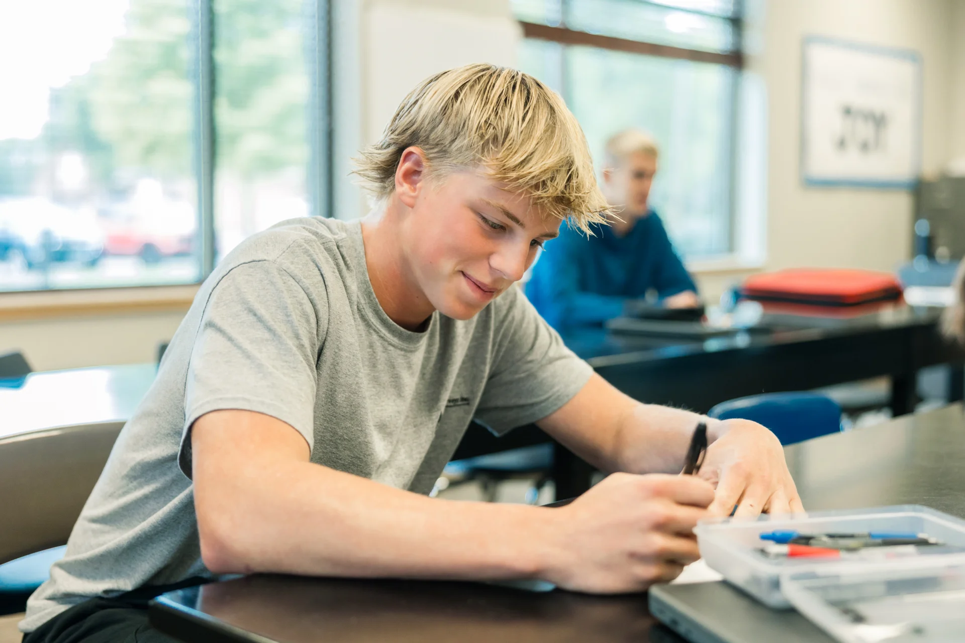 male student working at a school desk